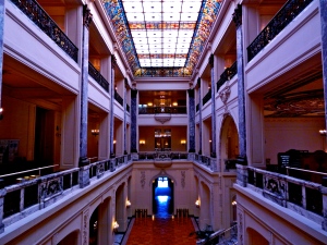 Grand Hall with main three levels and 100 foot long Venetian stained-glass skylight. 